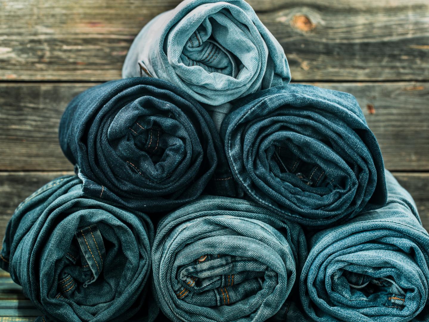 bunch-jeans-twisted-wooden-wall-fashionable-clothes website
